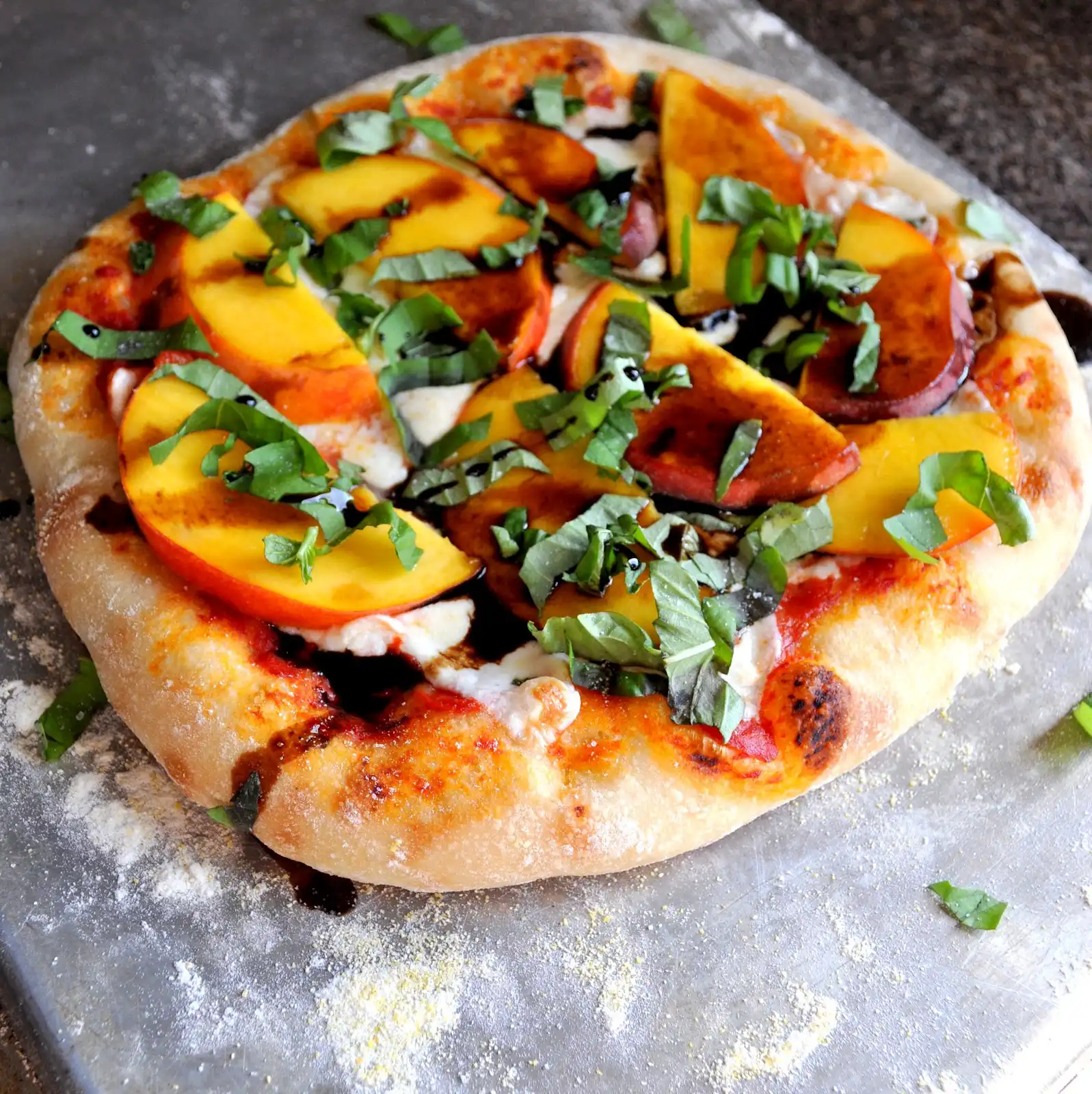 fresh peaches and basil on ricotta pizza
