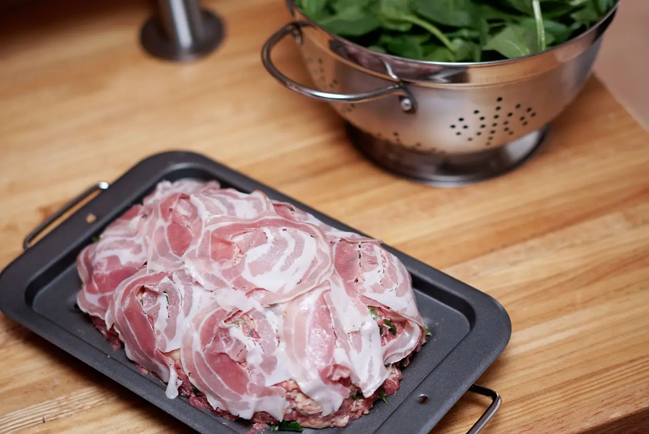 pancetta slices on a black platter